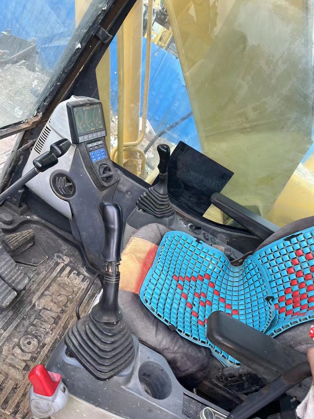 Operator controls inside a used Komatsu PC200-8 excavator cab